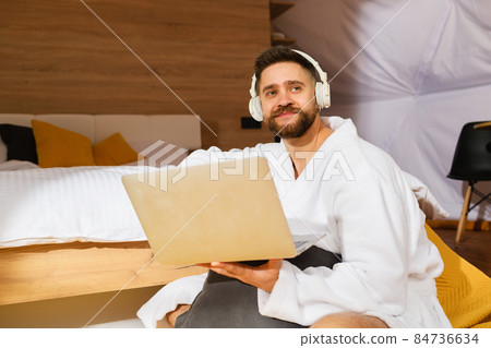 Young bearded man with headphones and laptop 84736634