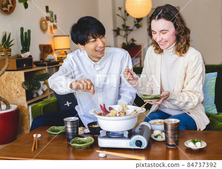Couple eating hot pot dishes 84737392