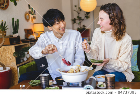 Couple eating hot pot dishes 84737393