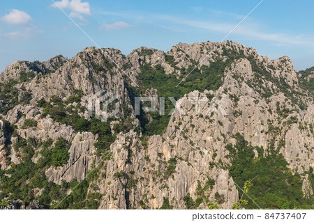 Scenic landscape view of limestone mountain with cliff in tropical forest. Scenic landscape view of limestone mountain with cliff in tropical forest. 84737407