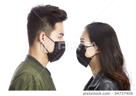 young asian man and woman wearing black mask staring at each other, isolated on white background. 84737408