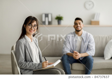 Successful treatment concept. Confident arab female psychologist and young man smiling after effective therapy 84737637