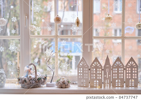 winter decor on windowsill with decor, basket with Christmas balls winter decor on windowsill with decor, basket with Christmas balls 84737747
