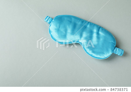 Blue sleep mask on gray background, space for text Blue sleep mask on gray background, space for text 84738371