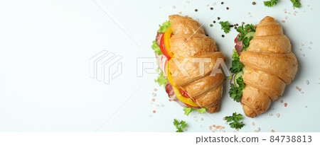 Concept of tasty eating with croissant sandwiches, space for text 84738813