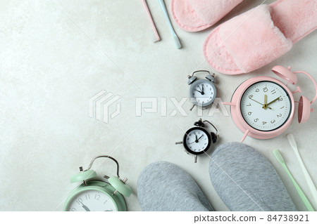 Different sleep routine accessories on white textured table 84738921
