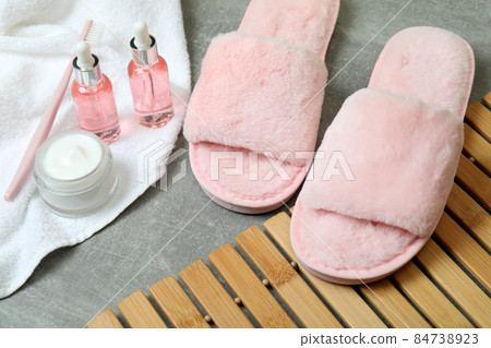 Female sleep routine accessories on gray textured table 84738923