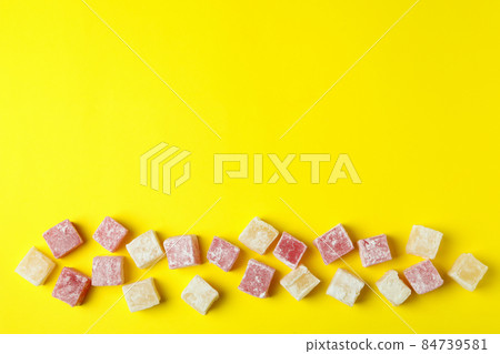 Delicious turkish delight on yellow background, space for text Delicious turkish delight on yellow background, space for text 84739581
