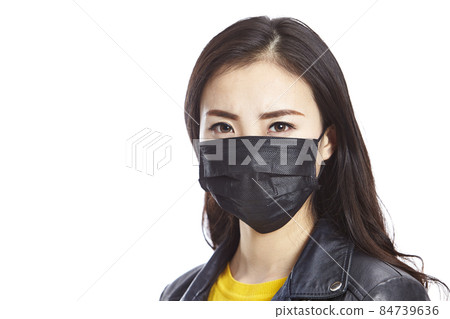 young asian woman wearing black mask staring at camera, isolated on white background. young asian woman wearing black mask staring at camera, isolated on white background. 84739636