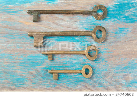 Old metal keys on wooden background Old metal keys on wooden background 84740608