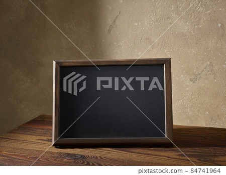 blackboard in a wooden frame on a table 84741964