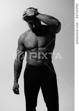Muscular shirtless tattooed guy in studio Muscular shirtless tattooed guy in studio 84742040