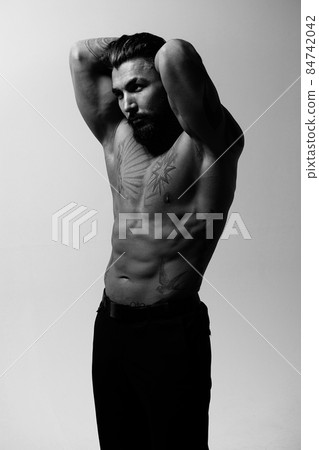 Muscular shirtless tattooed guy in studio Muscular shirtless tattooed guy in studio 84742042