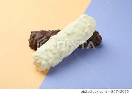 Tasty candy bars on two tone background Tasty candy bars on two tone background 84742075