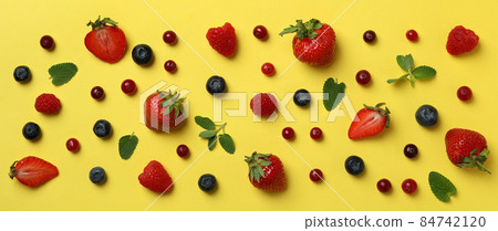 Delicious fresh berry mix on yellow background Delicious fresh berry mix on yellow background 84742120