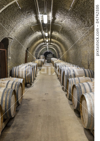 Wine cellars with barrels, traditional wine called Bikaver near Eger, Hungary Wine cellars with barrels, traditional wine called Bikaver near Eger, Hungary 84742886