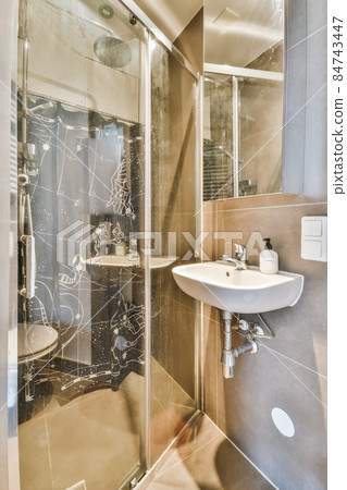 Interior design of an elegant bathroom with shower tall 84743447