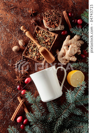 White mug and ingredients for making a winter hot drink. 84743715