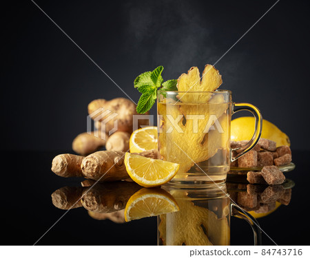 Ginger tea with ingredients on a black background. 84743716
