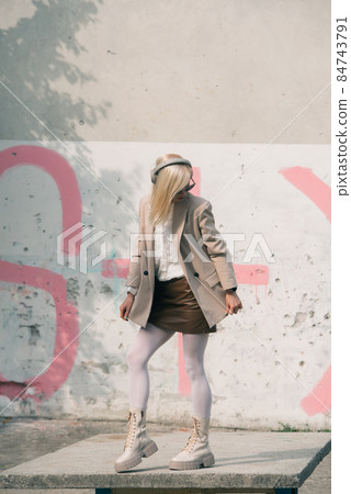 Portrait of blonde woman in headphones and sunglasses . Hipster fashion model wear stylish wireless headphones enjoy listen new cool music. Portrait of blonde woman in headphones and sunglasses . Hipster fashion model wear stylish wireless headphones enjoy listen new cool music. 84743791