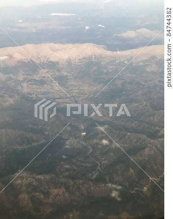 Aerial view of the mountains in the clouds Aerial view of the mountains in the clouds 84744382