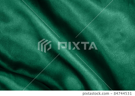 Elegant smooth green silk or satin folds closeup. Cloth texture background. Abstract wallpaper. Trendy mint green backdrop for web design. Luxury twisted fabric backplate  84744531