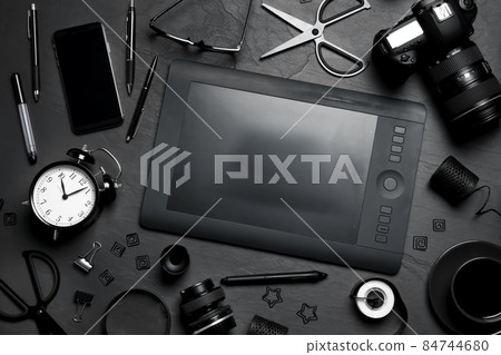 Flat lay composition with graphic drawing tablet and different office items on grey stone background Flat lay composition with graphic drawing tablet and different office items on grey stone background 84744680
