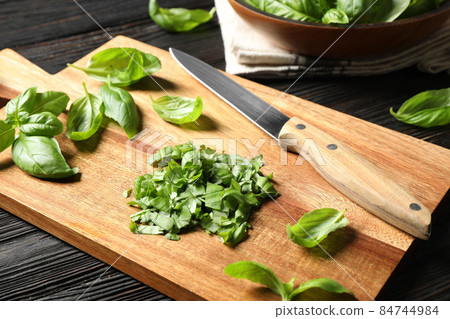 Fresh green basil on black wooden table 84744984