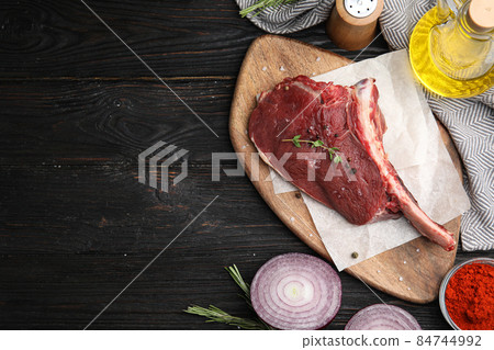 Flat lay composition with fresh beef cut on wooden table. Space for text Flat lay composition with fresh beef cut on wooden table. Space for text 84744992