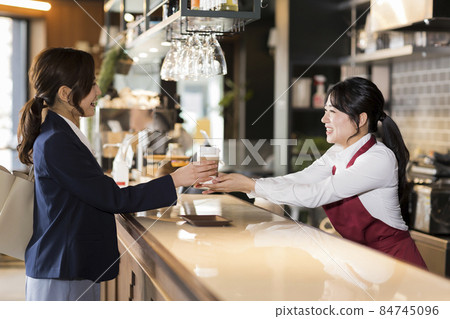 A young woman working in a cafe A young woman working in a cafe 84745096