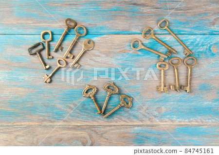 Old meal keys on wooden background Old meal keys on wooden background 84745161