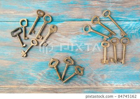 Old meal keys on wooden background Old meal keys on wooden background 84745162
