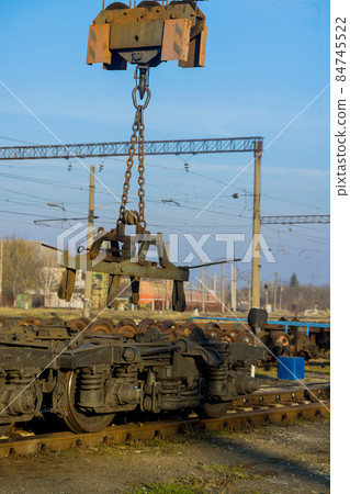 Main railway stations in depot with industrial crane that raises the driving wheels for train 84745522