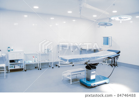 Empty interior operating room and modern equipment in hospital. Medical device for surgeon surgical emergency patient in blue tone style. Save life medical treatment concept. Empty interior operating room and modern equipment in hospital. Medical device for surgeon surgical emergency patient in blue tone style. Save life medical treatment concept. 84746488