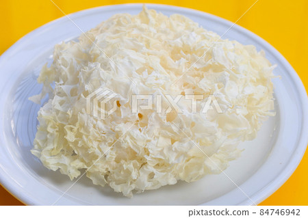 Tremella Mushroom in white plate on yellow background. 84746942