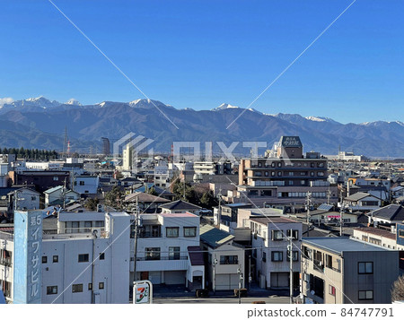 The city of Shiojiri, Nagano Prefecture and the mountains of the Northern Alps The city of Shiojiri, Nagano Prefecture and the mountains of the Northern Alps 84747791