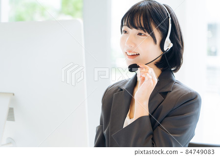 Female operator working at a call center Female operator working at a call center 84749083