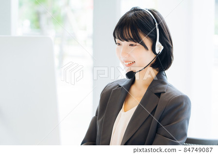 Female operator working at a call center Female operator working at a call center 84749087