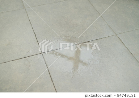 Water drips onto the tiled floor. Water drips onto the tiled floor. 84749151