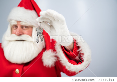Santa Claus holds keys on a white background. New home gift for christmas. Santa Claus holds keys on a white background. New home gift for christmas. 84749153
