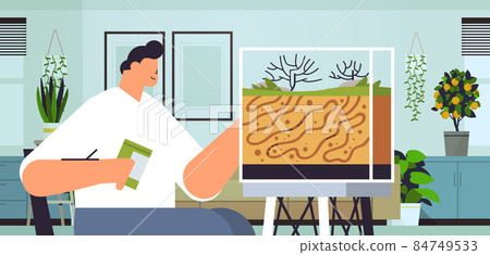 young man taking care of ant farm guy feeding ants in formicarium domestic insects concept living room interior young man taking care of ant farm guy feeding ants in formicarium domestic insects concept living room interior 84749533