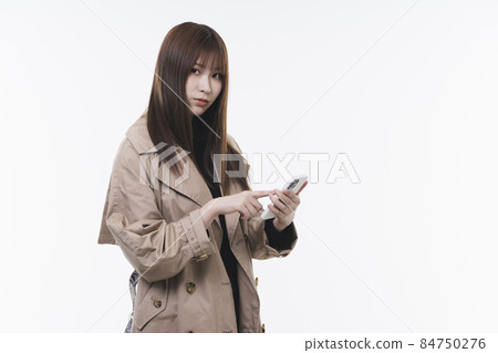 Cool lady using a smartphone Cool lady using a smartphone 84750276