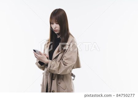 Cool lady using a smartphone Cool lady using a smartphone 84750277