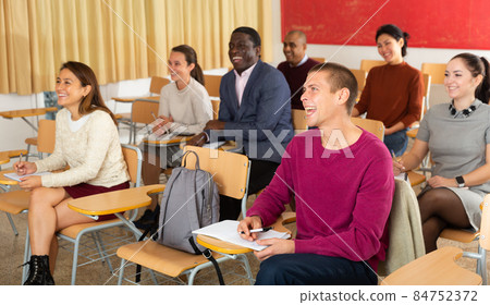 Adult students in studying with their colleagues, Focus on european man 84752372