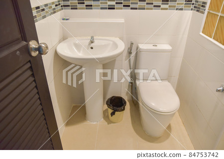sanitary ware or toilet of a resort or hotel bathroom, white room and no one in the picture. 84753742