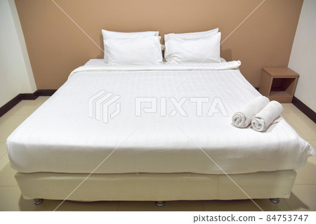 White single bed set and pillows and blankets of resort or hotel room, white room and free space in picture. 84753747
