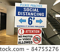 American corona vaccine intake venue, social distance caution sign. 84755276