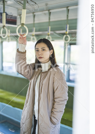 A woman riding a train A woman riding a train 84756950