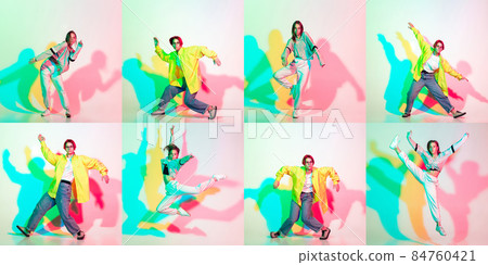 Two stylish girls, teens dancing hip-hop in stylish clothes on colored studio background with glitch effect. Two stylish girls, teens dancing hip-hop in stylish clothes on colored studio background with glitch effect. 84760421