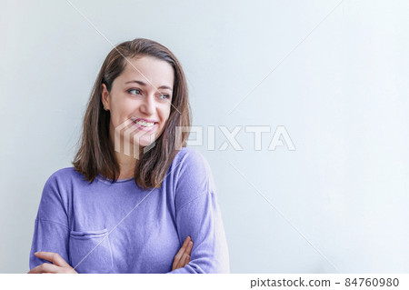 Young happy positive smiling woman, clothes blouse shirt colored in trendy color of year 2022 Very Peri, white background isolated. Inspired by using color 17-3938, Color of the year concept Young happy positive smiling woman, clothes blouse shirt colored in trendy color of year 2022 Very Peri, white background isolated. Inspired by using color 17-3938, Color of the year concept 84760980